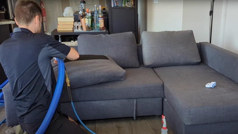 professional cleaner steam cleaning gray dyed sectional
