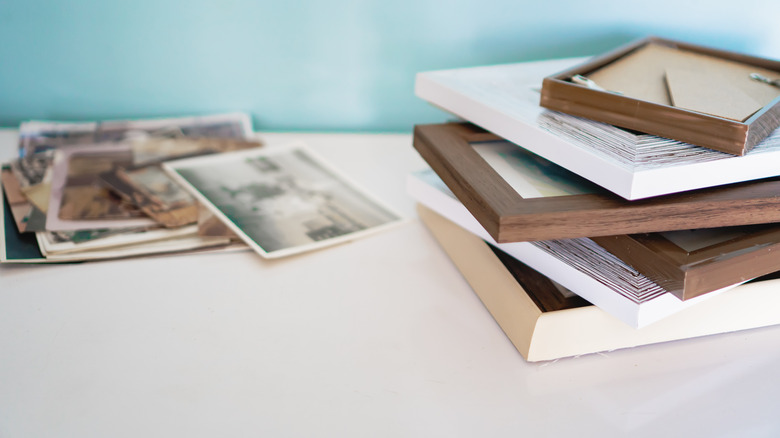 A stack of photos with cheap picture frames.