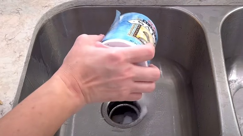 woman uses salt lemon and ice to clean garbage disposal