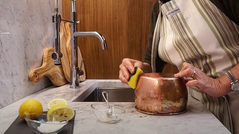 polishing copper pot with lemon and salt