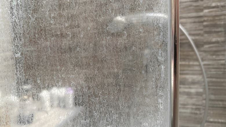 limescale and soap scum on shower door