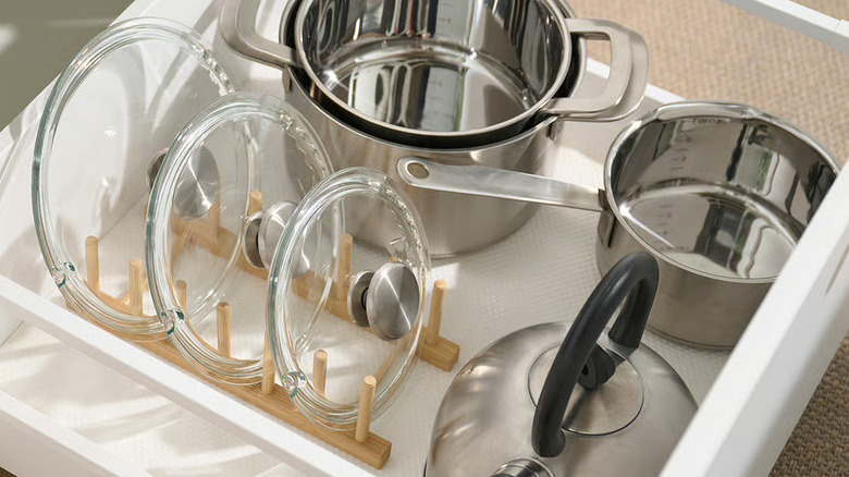 Bamboo plate holder in pot and pan drawer with lids