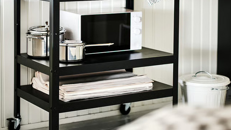 Stainless steel cooking pots on rolling kitchen island