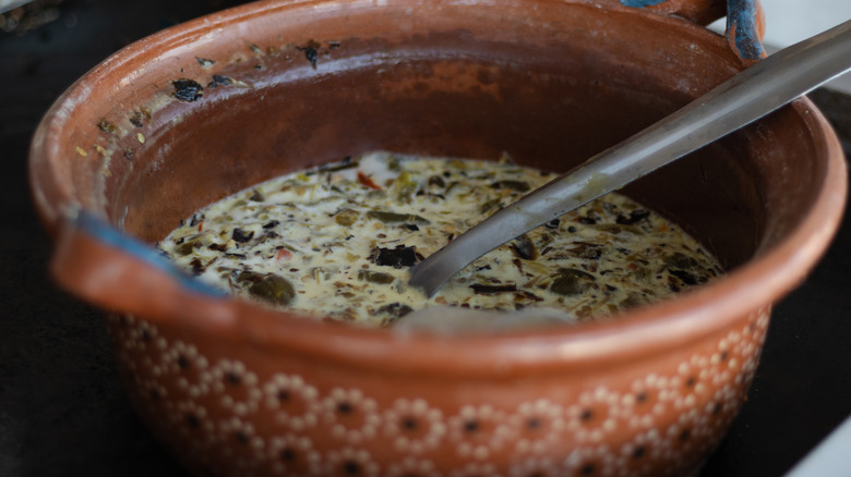 A traditional Mexican hand painted pan full of soup.