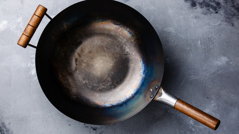 A wok with wooden handles.