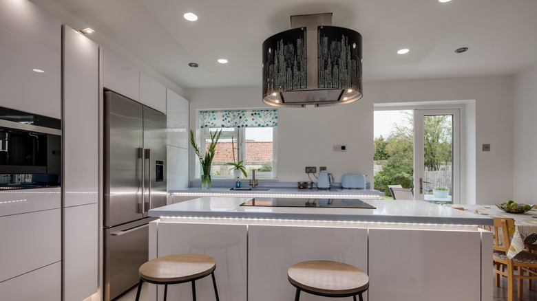 Corian countertops in a modern kitchen with LED underlights.