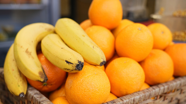 Close up of fruit basket with bananas and oranges