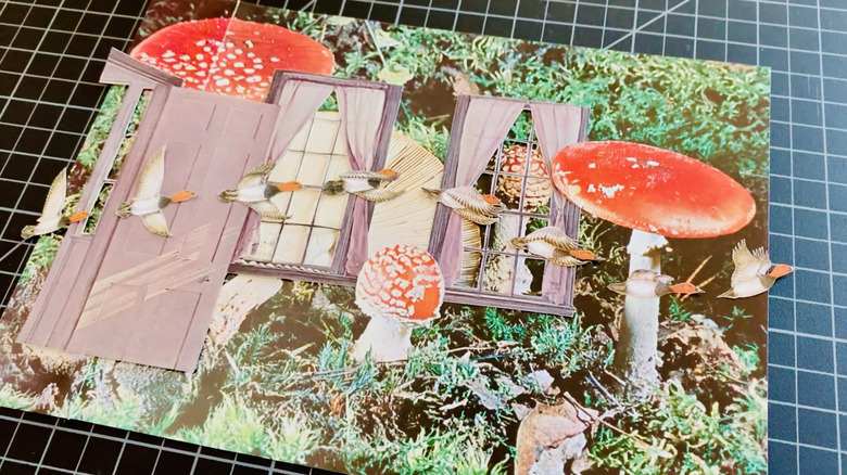 Collaged items have been placed on this thrift-store art print.