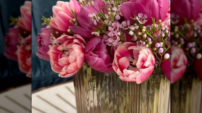 peony tulips and wax flowers in a fluted vase