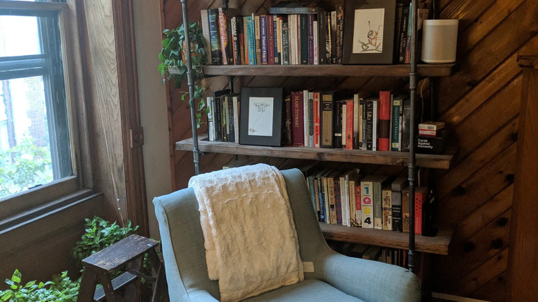 Solid wood bookcase and decorative stepladder in rustic office