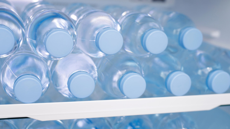 Plastic water bottles stacked in freezer