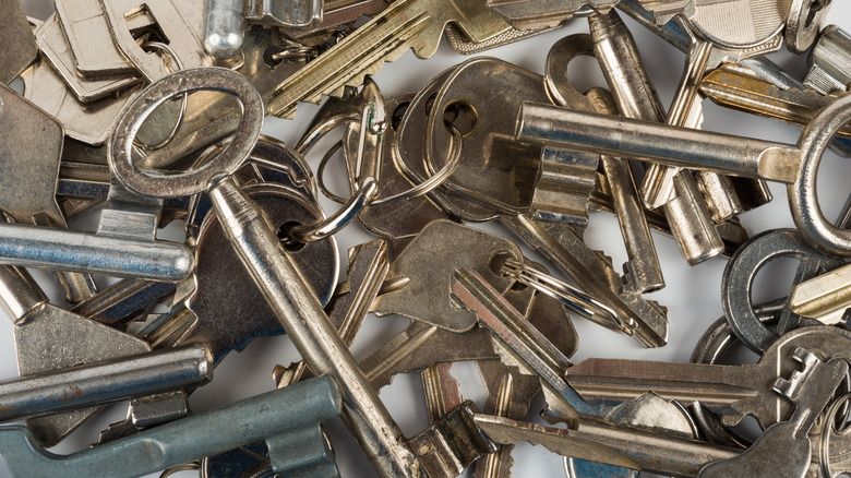 A pile of keys displayed on a white surface