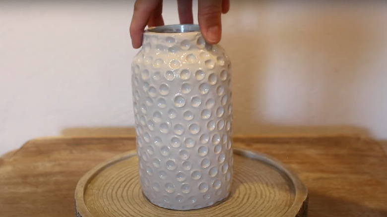 white vase on table with indents in it