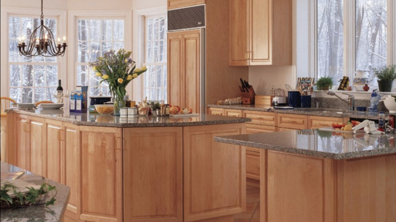 A kitchen with High-gloss light maple cabinets