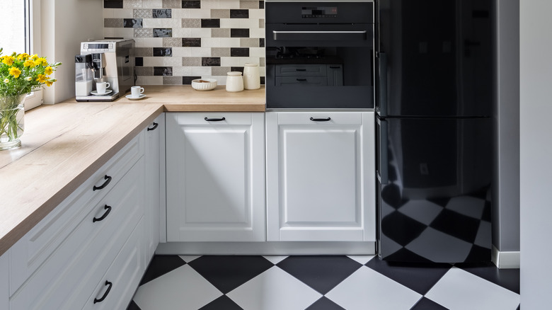 modern neutral white kitchen with checkerboard blooring