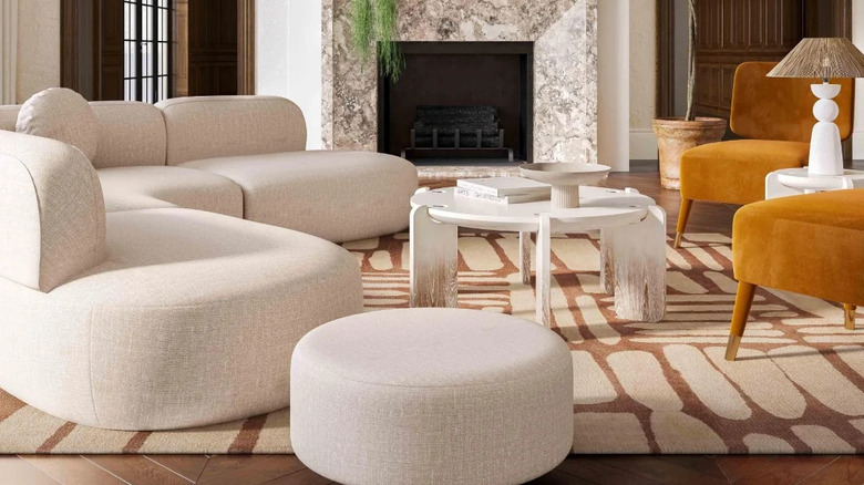 A room with a large, curvy couch