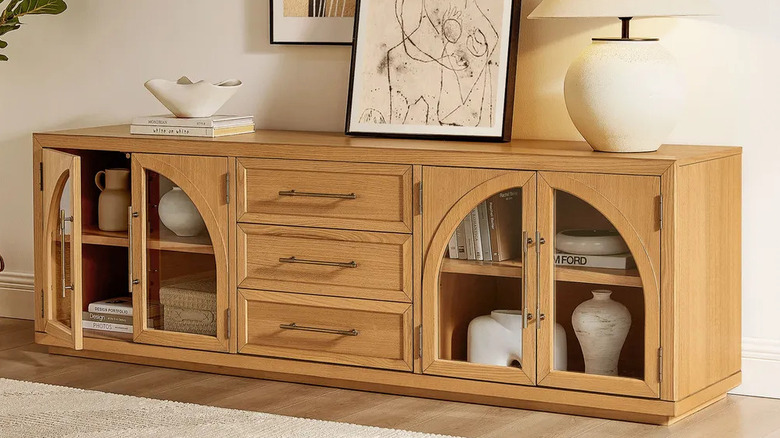 A honey oak wood credenza with white decor