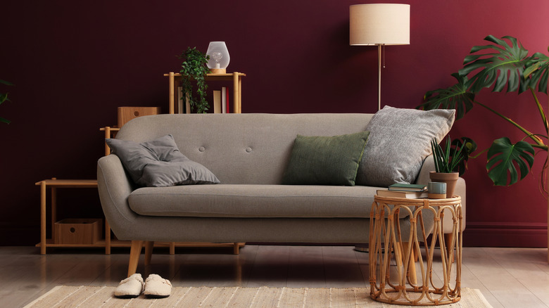 A burgundy living room with neutral furniture