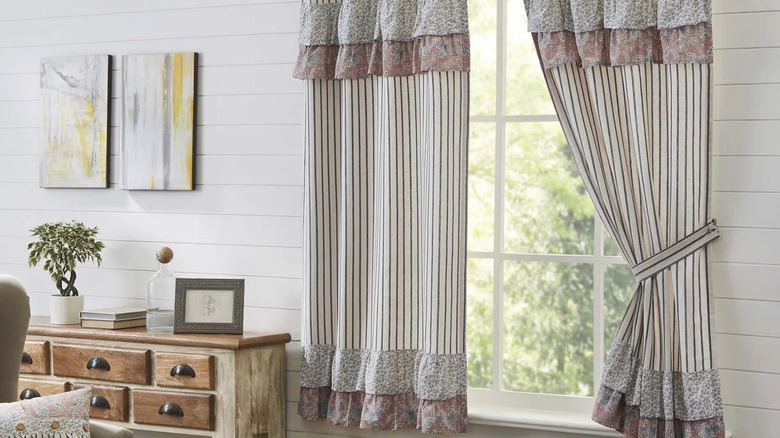 A window with mixen-patterend ruffle curtains