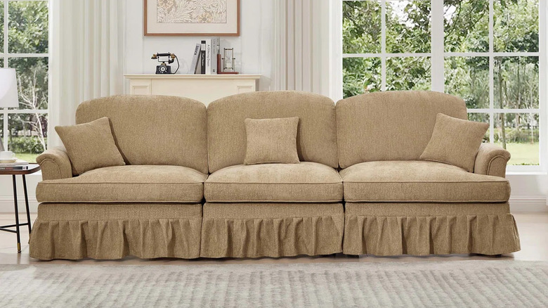 A ruffled sofa in a neutral living room