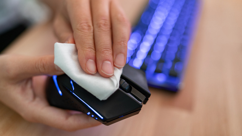 person wiping down mouse