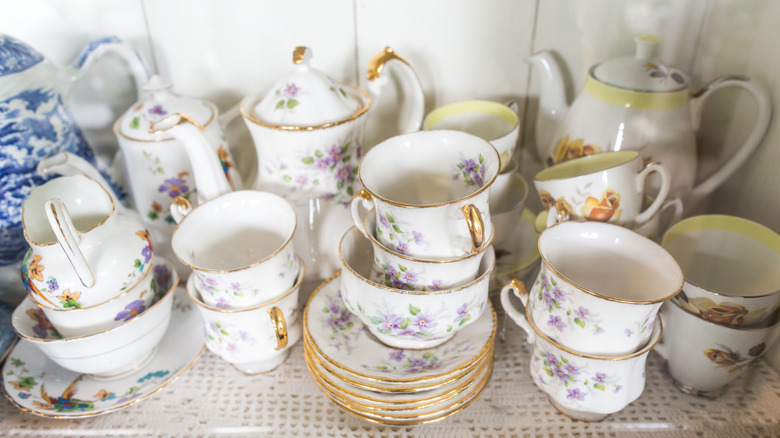 Several vintage tea sets placed on a table