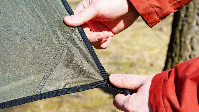 Person holding tarp