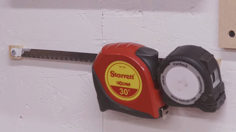Tape measures on wall-mounted rack