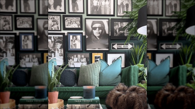 A black and white gallery wall with '90s photos.