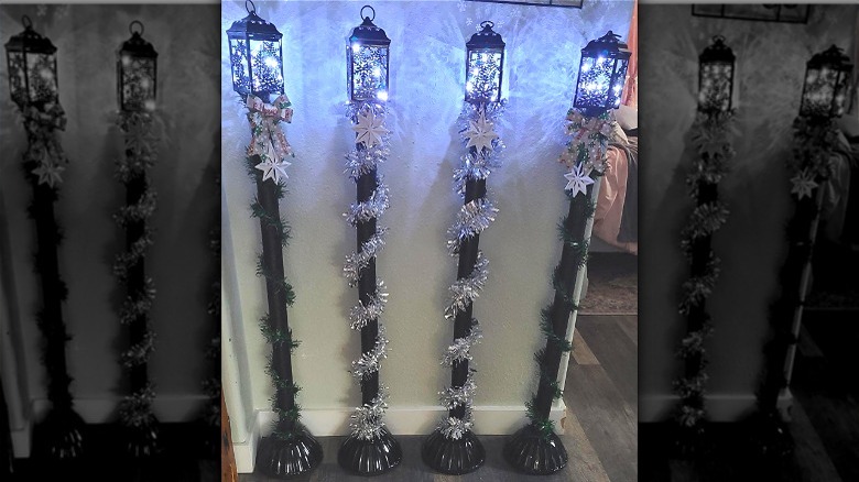 Four DIY Christmas lamp post decorations with silver snowflake decor