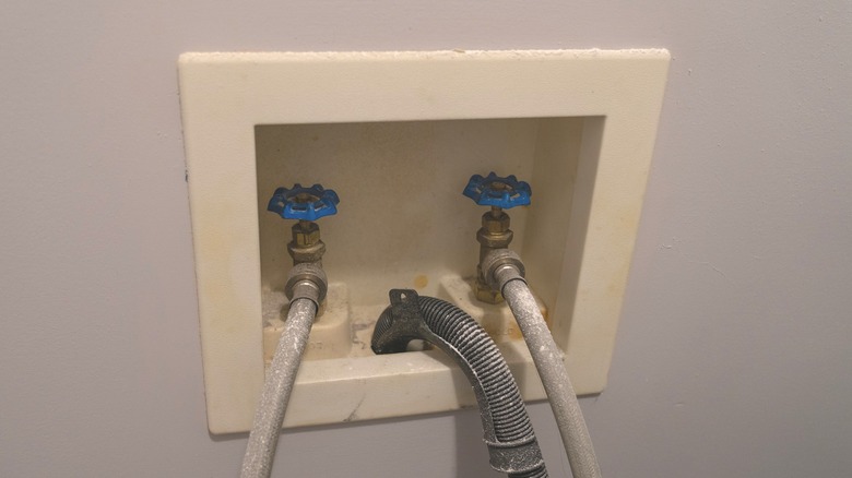 Washer hook up with plumbing cables and drain