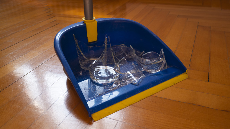 Broken glass in dustpan