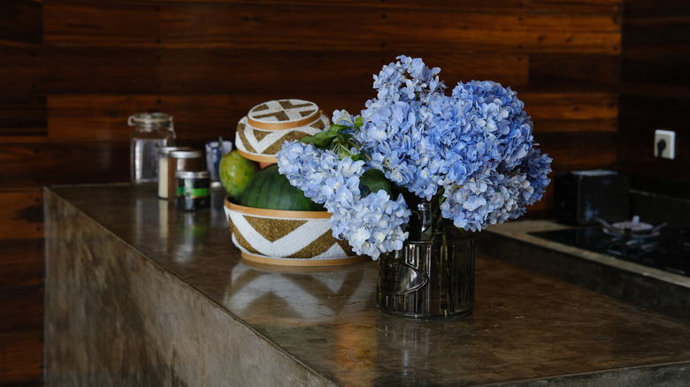 A fruit basket filled with various fruits in a kitchen.