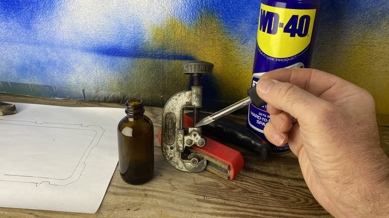 Lubricating a seized old pipecutter using WD-40 in a dropper