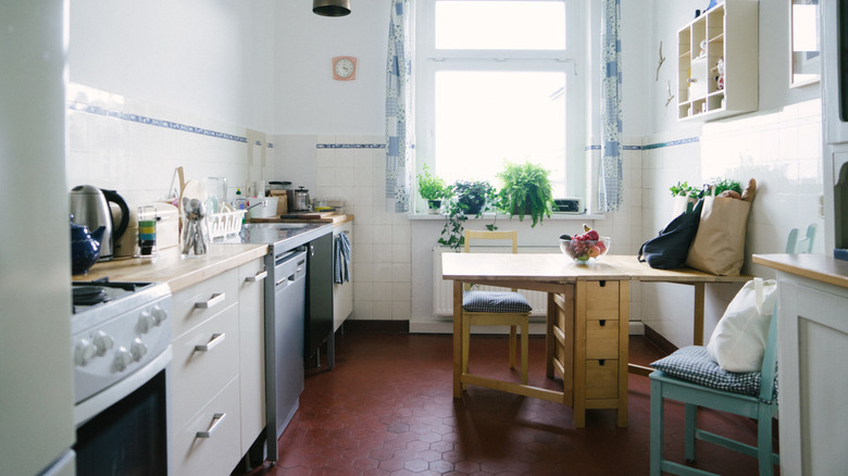 Small apartment kitchen with a table and chairs