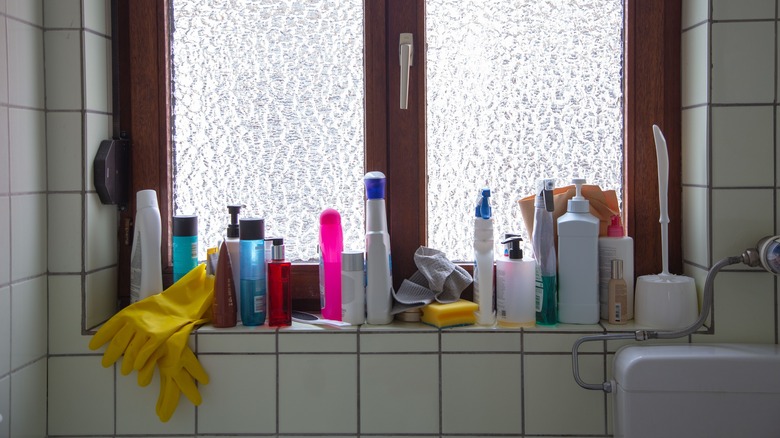 messy and cluttered bathroom window sill