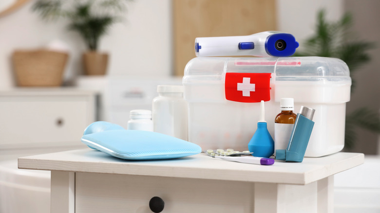first aid kit sitting on a counter surrounded by medical supplies
