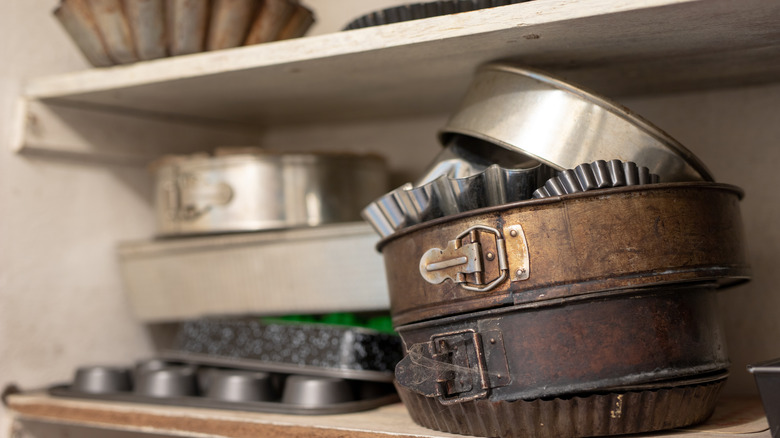 A stack of round cake pans in the cupboard