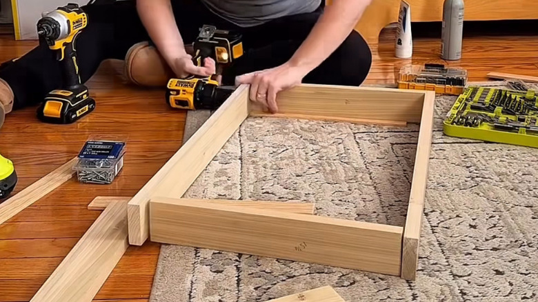 building a roll out storage cabinet starting with a sturdy wooden frame made with 1-by-3s