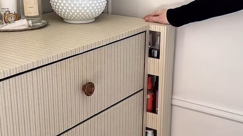 a slide out storage compartment next to a dresser eradicates dead space