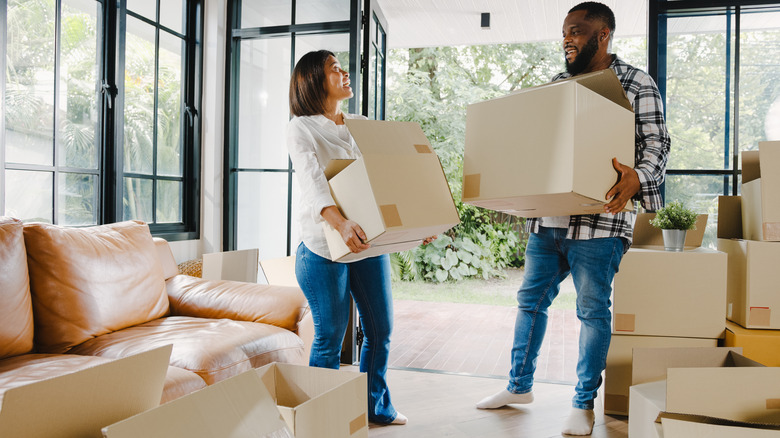 happy couple with moving boxes