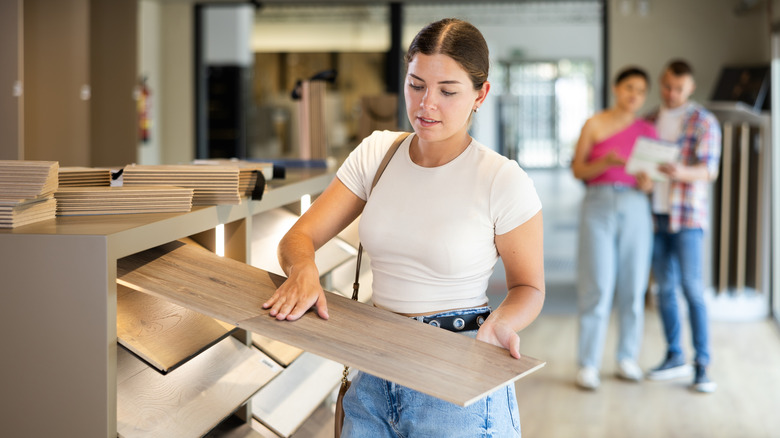 Person shopping for wood panels