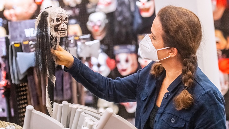 woman shops for Halloween decor