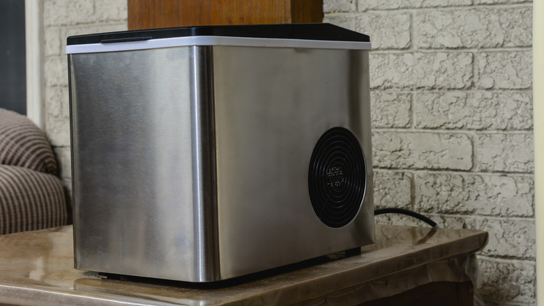 A stainless steel portable ice maker in a kitchen