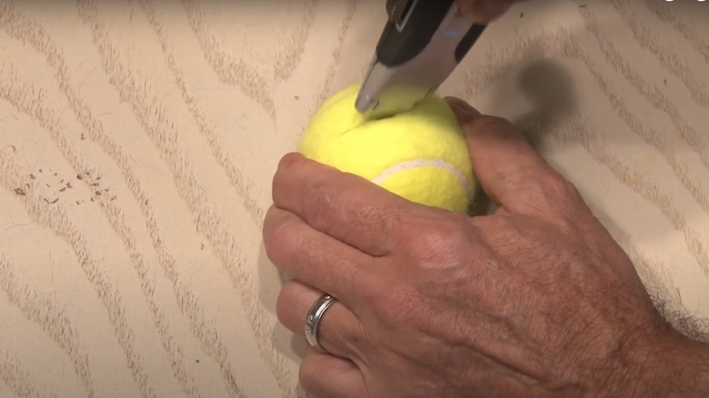 Someone cutting tennis ball
