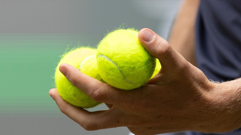 Person holding tennis balls