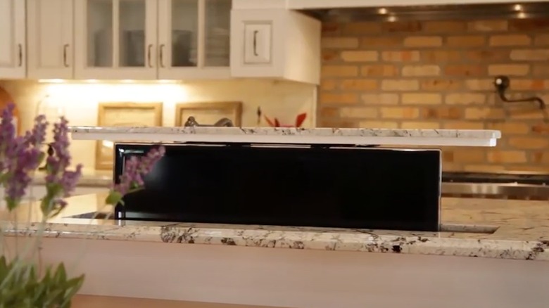 Image of TV lifting out of kitchen island countertop