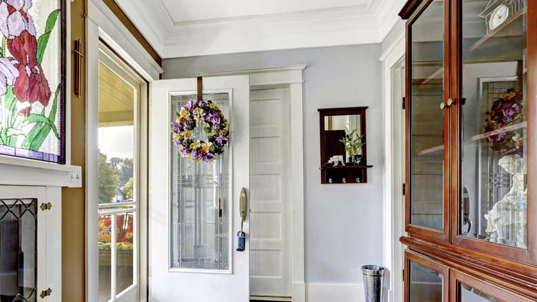 entryway foyer with vintage china cabinet off to the side