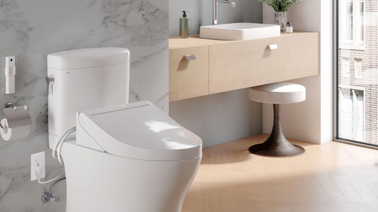 Toto's Washlet toilet seat in white attached to a toilet.
