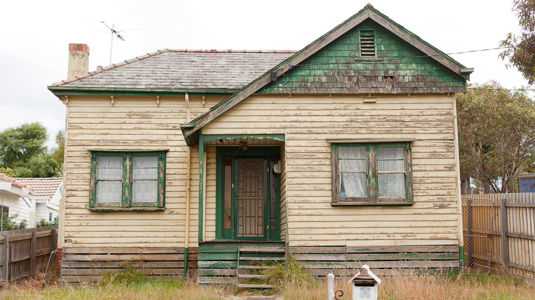 an abandoned home sits in disrepair